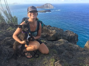 Jenny Stahl, health coach, and pooch in Hawaii on mountaintop